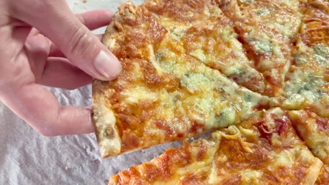 Close up view on Hand taking a slice of pizza from pizza box. Four cheeses pizza Stock Footage 255914938