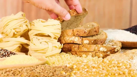 A close up view of a hand taking slice of fresh wholemeal bread from a stac.. Stockbeeldmateriaal 333495905