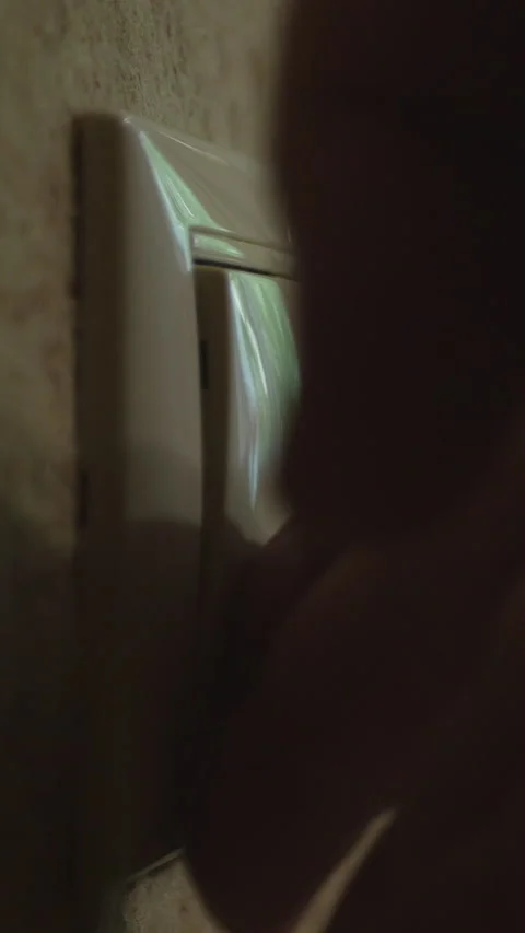 A Close-Up View Of A Hand Turning Off A Light Switch, Causing The Room To Dim, H Stock Footage 312981118