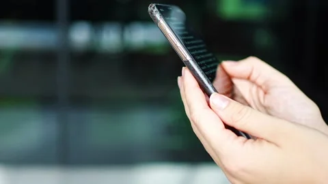 Close up view of hand of woman reading a online book on her smartphone Stock Footage 265077413
