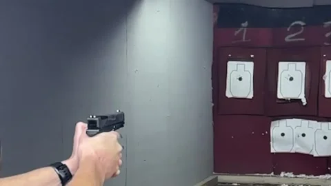 Close-up view of a handgun with ammunition Video stock 294722920