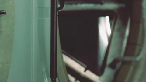 Close view of a handle on a washing machine in a laundry area Vidéo 344314639