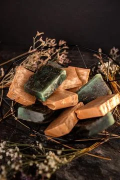 A Close-Up View of Handmade Soap Bars With Natural Herbs and Subtle Light Stock Photos