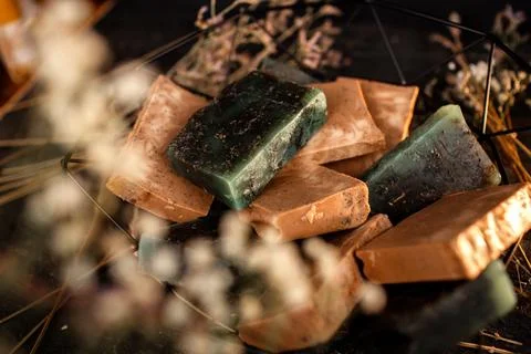 A Close-Up View of Handmade Soap Bars With Natural Herbs and Subtle Light Stock Photos