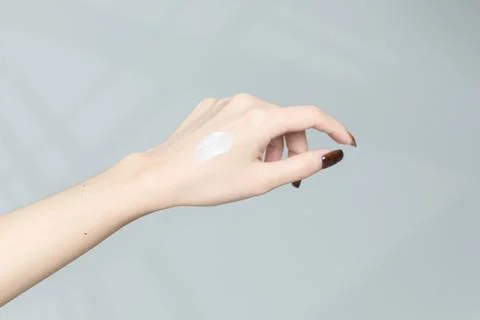 Close-up view of hands applying cream Stock Photos