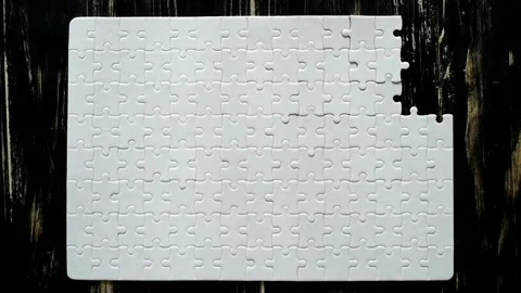 Close up view of hands assembling jigsaw puzzle on table, group of business Stock-Footage 336248718
