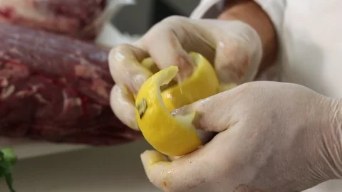 Close-up view of the hands of the chef carving a lemon Stock Footage 121598134