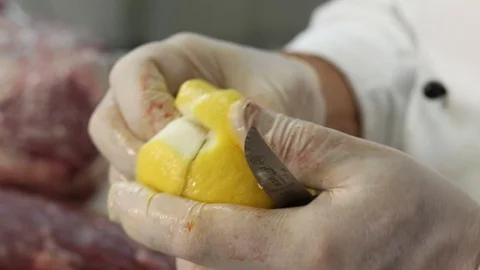 Close-up view of the hands of the chef carving a lemon Stock Footage 122170771