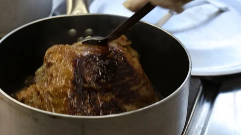 Close-up view of the hands of the chef preparing braised beef in the pot Stock Footage 121597779