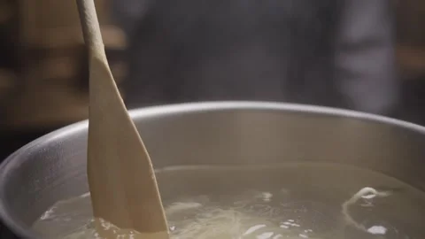 Close-up view of hands of chef stirs the pasta in the pan. Stock Footage 314241785