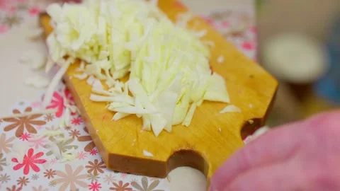 Close up view of hands chopping cabbage on wooden cut board. Process of cooking Stock Footage 149249678