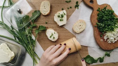 Close-up view of the hands cutting the bread. The breakfast composition Stock Photos