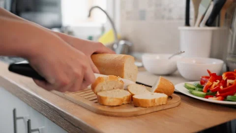 Close-up view of  hands cutting fresh loaf of french baguette bread with kn.. Stock Footage 327839912