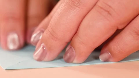 Close Up View of Hands Folding Blue Origami Paper on Table Stock Footage 327107657