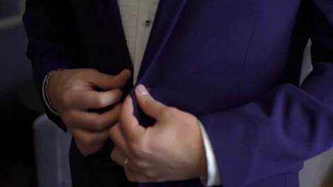 Close-up view of the hands of the groom buttoning the wedding jacket. 動画素材 95749110