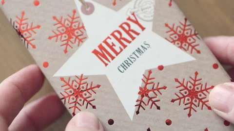 Close-up view of hands holding red Christmas gift box putting present for winter Video stock 158734500