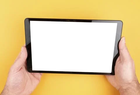 Close-up view of hands holding tablet computer with copy space on screen against Stock Photos