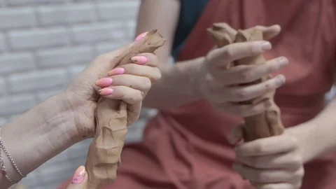 A close-up view of the hands of a man and woman sculpting clay . Stock Footage 128577659