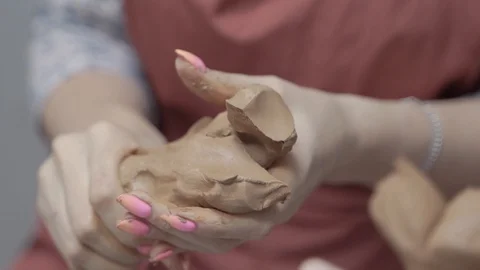 A close-up view of the hands of a man and woman sculpting clay . Stock Footage 128577667