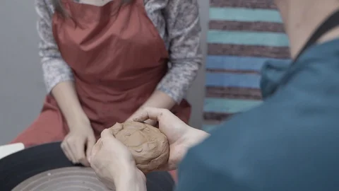 A close-up view of the hands of a man and woman sculpting clay . Stock Footage 128577744