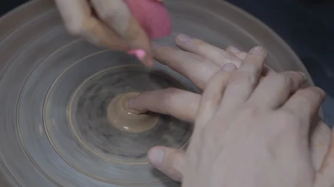 A close-up view of the hands of a man and woman sculpting clay . Stock Footage 128577801