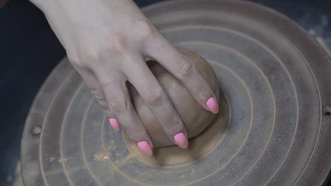 A close-up view of the hands of a man and woman sculpting clay . Stock Footage 128577814