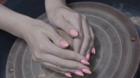 A close-up view of the hands of a man and woman sculpting clay . Stock Footage 128577816