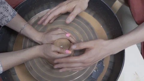 A close-up view of the hands of a man and woman sculpting clay . Stock Footage 128577852