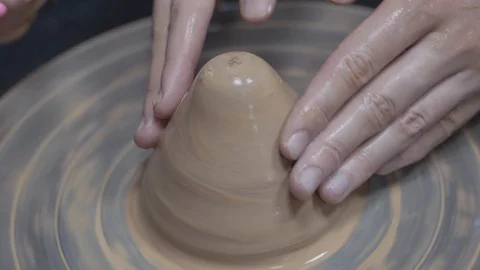 A close-up view of the hands of a man and woman sculpting clay . Stock Footage 128577872