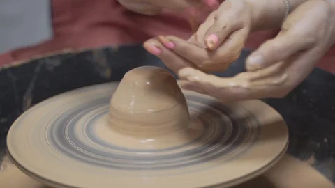 A close-up view of the hands of a man and woman sculpting clay . Stock Footage 128577917