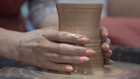 A close-up view of the hands of a man and woman sculpting clay . Stock Footage 128577975