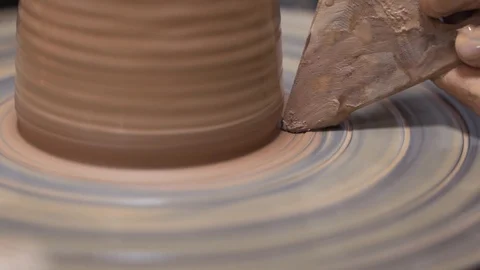 A close-up view of the hands of a man and woman sculpting clay. Stock Footage 128578001