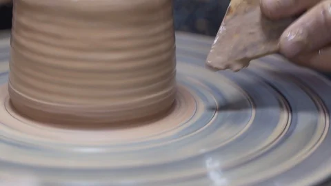 A close-up view of the hands of a man and woman sculpting clay. Stock Footage 128578027