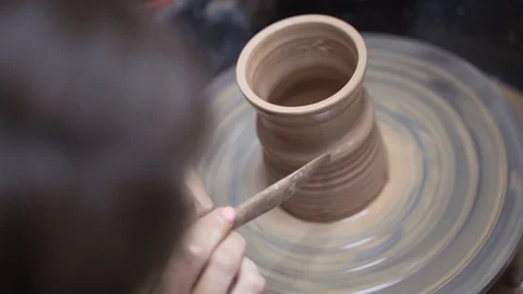 A close-up view of the hands of a man and woman sculpting clay. Stock Footage 128578042