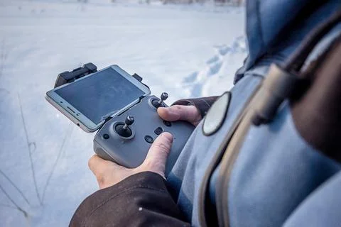 Close up view of hands of a man holding wireless remote control of drone Stock Photos