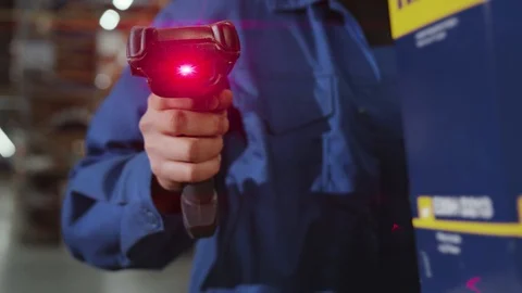 Close up view of the hands of a manufacturing worker hold scanner for products Stock Footage 116997038