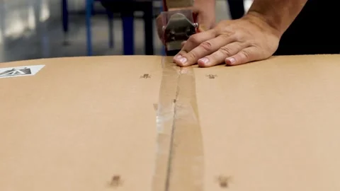 Close up view of the hands of a manufacturing worker packed products in card Stock Footage 147490308