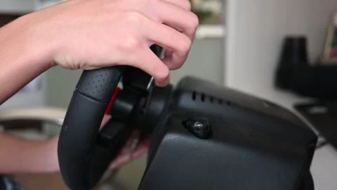 Close Up View of Hands Operating a Gaming Racing Wheel with Paddle Shifters. Stock Footage 311506433