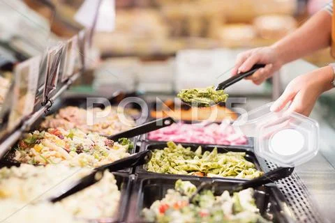 Close up view of hands picking prepared meals Stock Photos