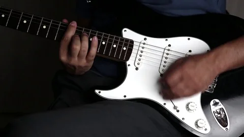 Close-up view of hands playing electric guitar Stock Footage 79589190