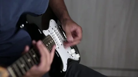Close-up view of hands playing electric guitar Stock Footage 79589210
