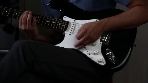 Close-up view of hands playing electric guitar Stock Footage 79589256