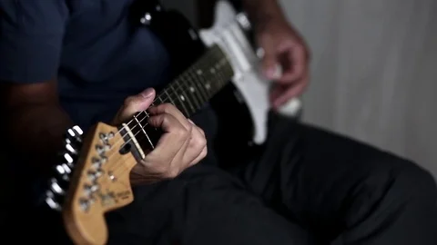 Close-up view of hands playing electric guitar Stock Footage 79589340