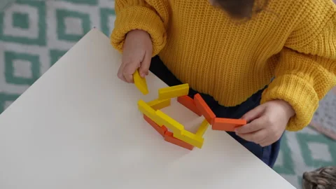 Close up view hands of preschooler playing with wooden blocks. Homeshooling Video stock 170068626