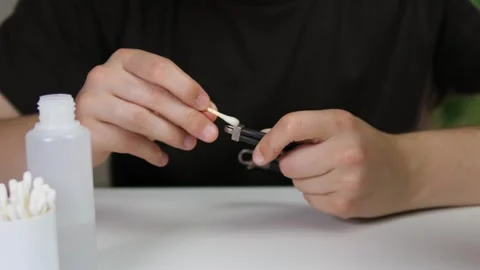 Close-up view of hands removing tarnish and dirt from a bracelet with precision Stock Footage 315175379