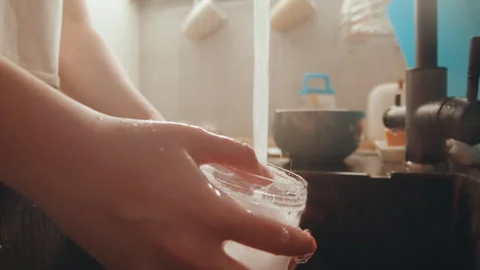 Close view of hands scrubbing glass with foam and water. Detail of hands Stock Footage 337461906