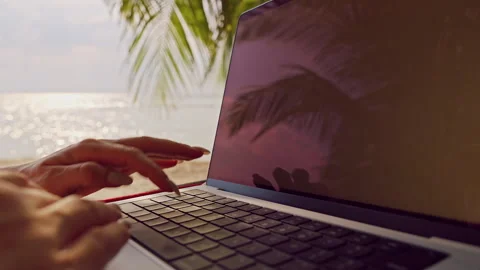Close View of Hands Typing on Laptop Keyboard While Resting in Hammock Creating Stock Footage 326939685