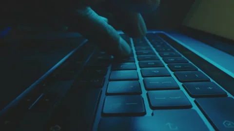 Close-up view of hands typing on a laptop keyboard in dimly lit room, showc.. Stock Footage 337406951