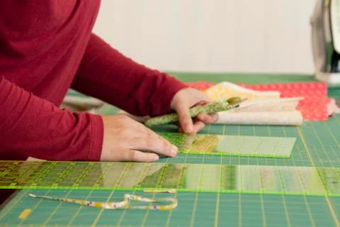 Close view hands working on a fabric grid Stock Photos