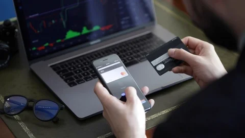 Close up view of hands working on the phone and checking the stock market Stock Footage 129303959